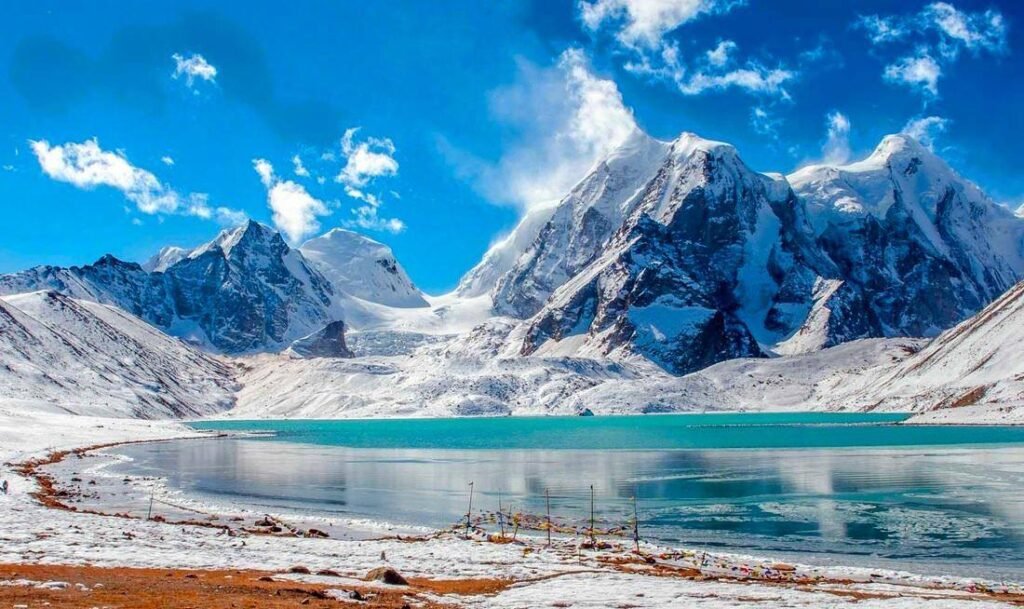 Pristine Gurudongmar Lake surrounded by snow mountains North Sikkim