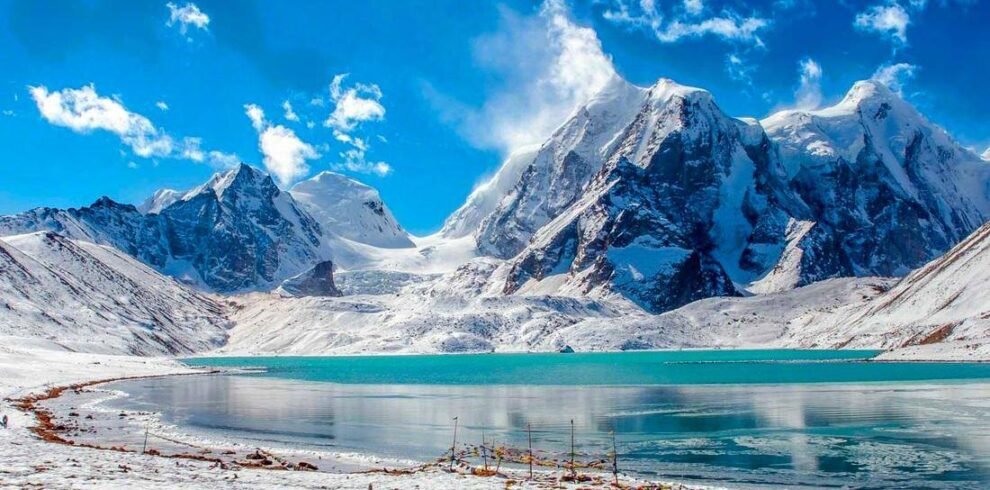 Pristine Gurudongmar Lake surrounded by snow mountains North Sikkim
