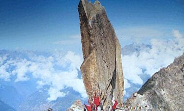 "Kinner Kailash peak with the sacred Shivlingam rock formation, surrounded by snow-capped mountains and rugged Himalayan terrain in Himachal Pradesh."