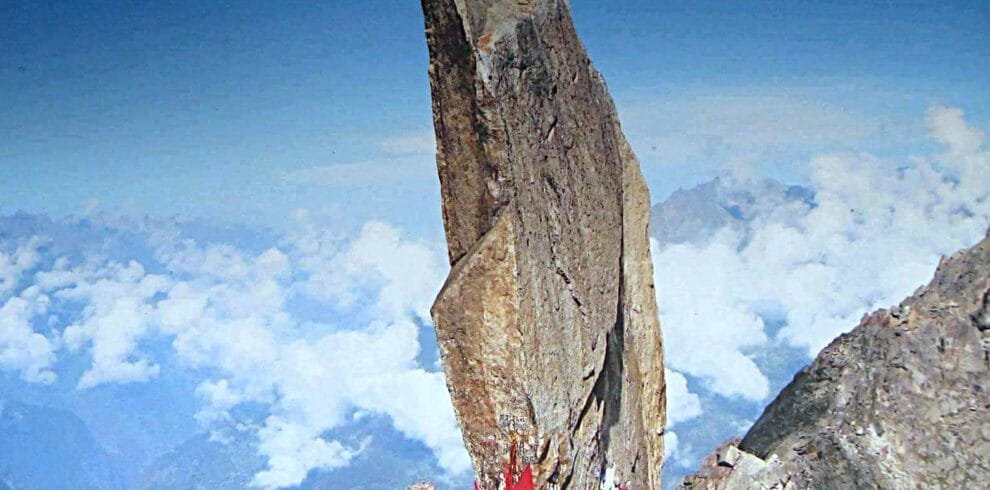 "Kinner Kailash peak with the sacred Shivlingam rock formation, surrounded by snow-capped mountains and rugged Himalayan terrain in Himachal Pradesh."